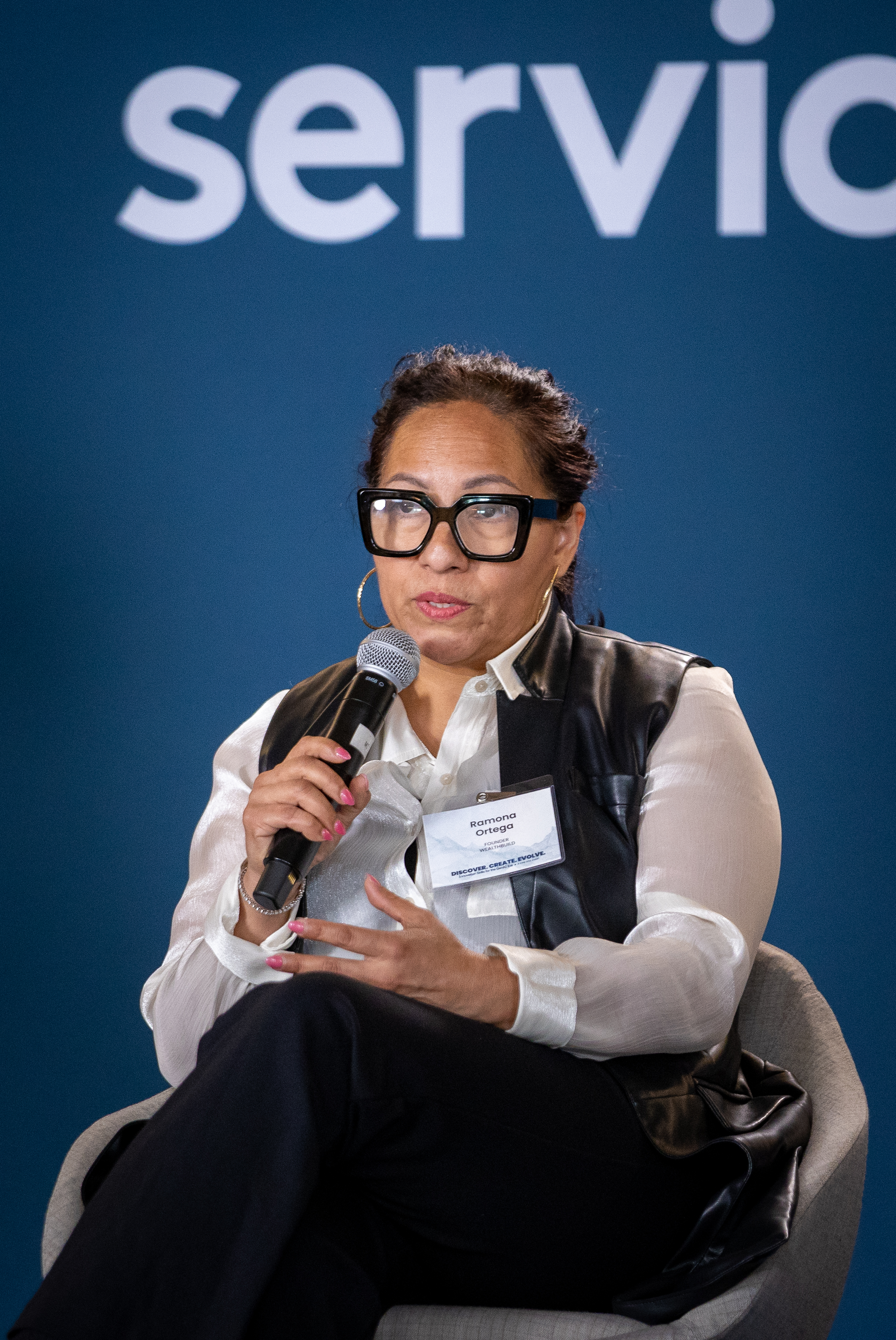 Ramona Ortega, J.D., speaking into a microphone during an AI panel